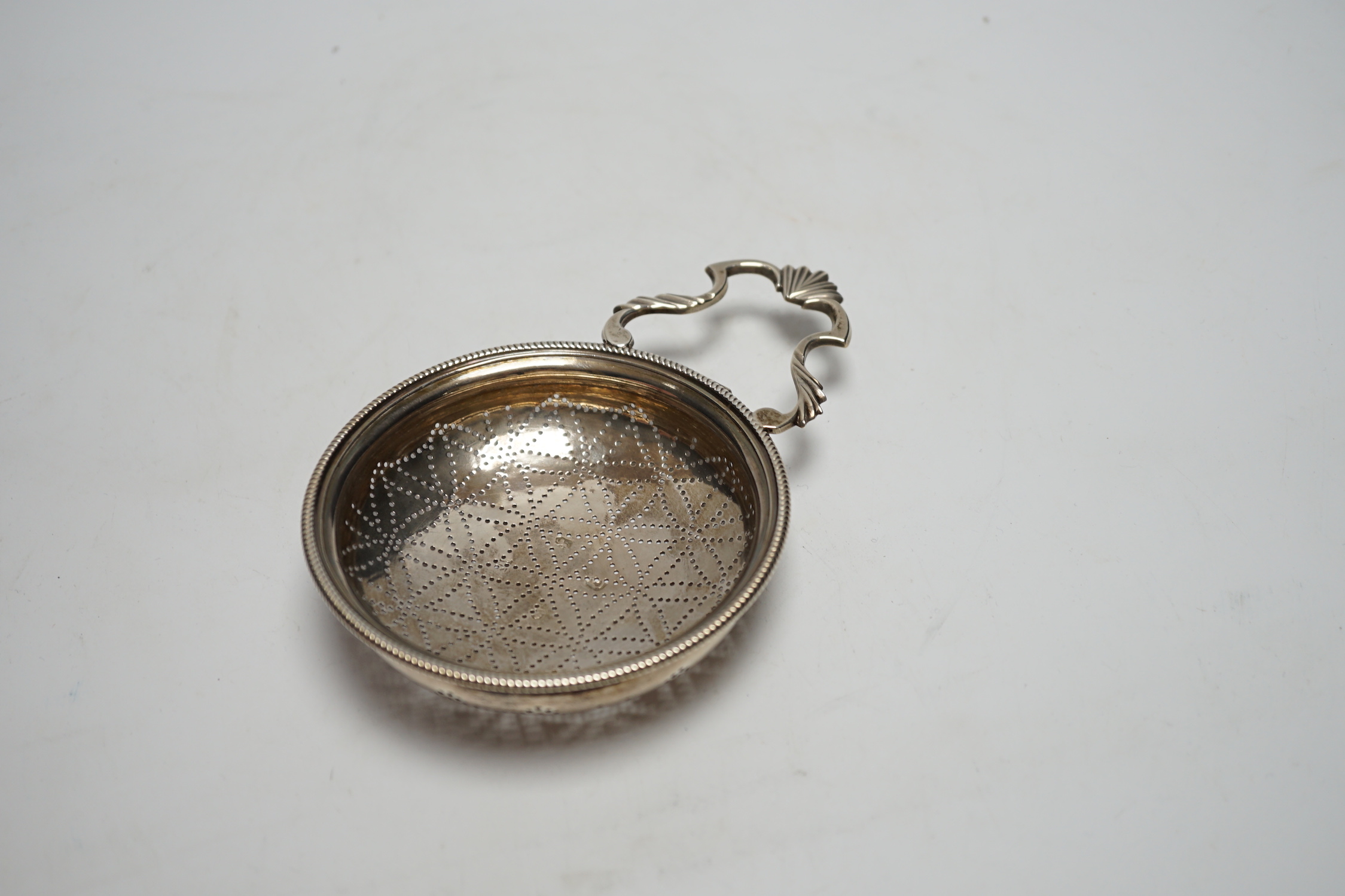 A late George II silver lemon strainer, maker WS?, London, 1759?, 14.7cm.